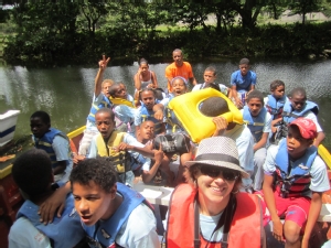 Adrienne Mallette shown in a boat with kids in the Dominican Republic